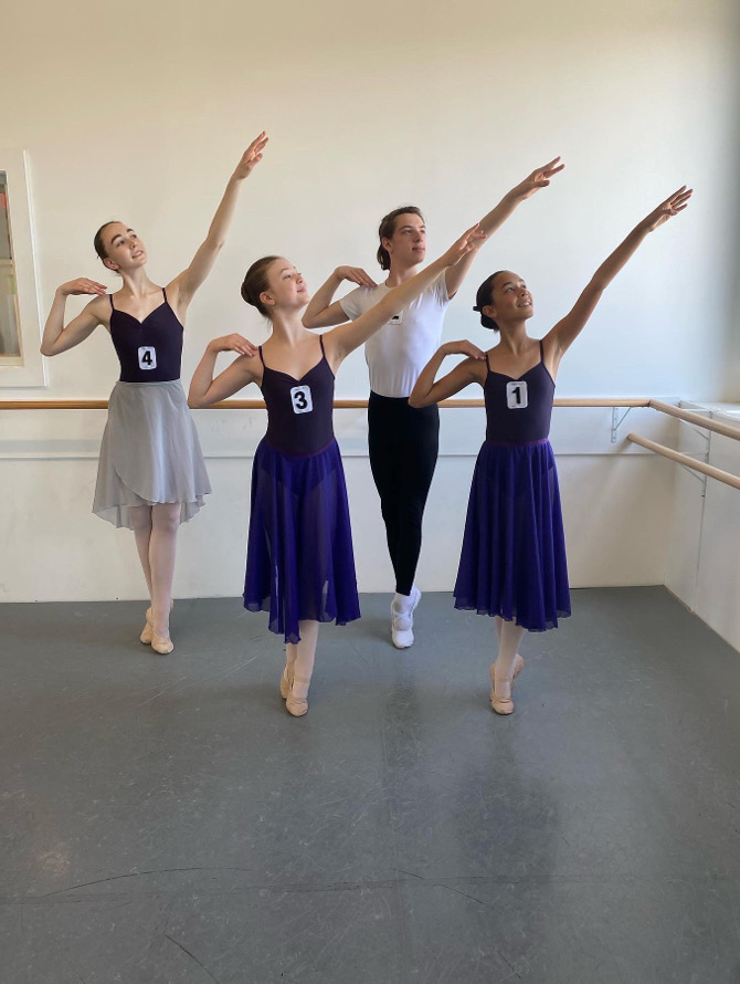 Four Metrowest Dance Academy students posing in a group setting for a Royal Academy of Dance (RAD) exam.