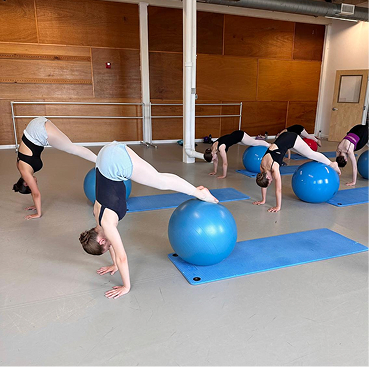 policies image 06 Older students performing strengthening exercises with a ball and a mat.